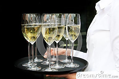 a-waiter-with-champagne-glasses-on-a-tray--thumb12728074.jpg