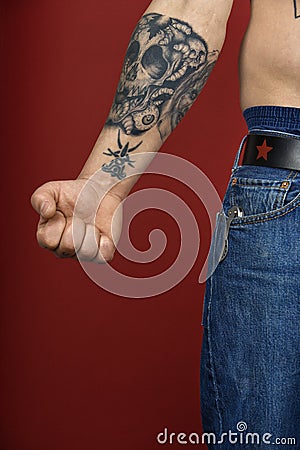 Stock Images: Adult male arm with tattoo.