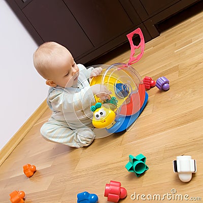 baby-playing-with-plastic-toy-thumb8299066.jpg