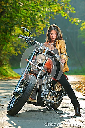 Biker Girl On A Motorcycle Royalty Free Stock Photos