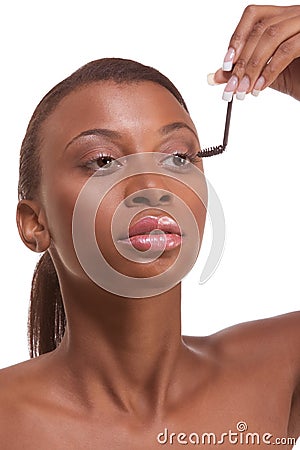 Applying Mascara on Black Woman Applying Mascara On Her Eyelashes Royalty Free Stock