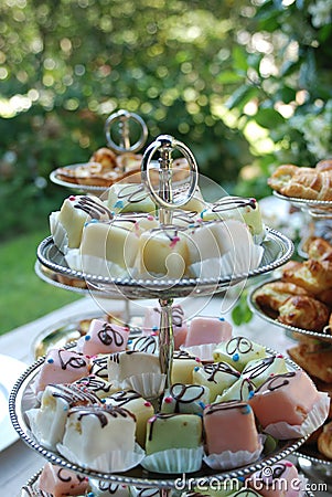 Colourful Petit Fours On A Cake Stand