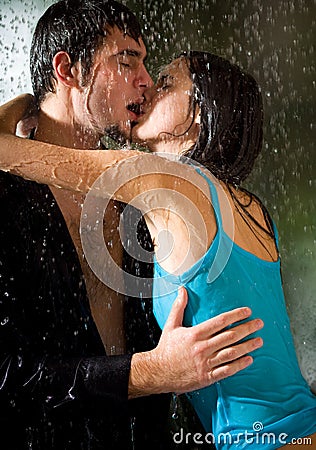 romantic couple kissing in rain. COUPLE KISSING UNDER A RAIN