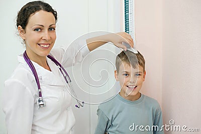 Doctor  Wallpaper on Doctor Measures Growth Boy In Medical Office Stock Photo   Image