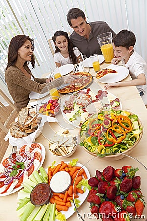 Family Eating Pizza & Salad At Dining Table