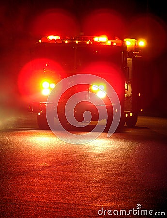 FIRE TRUCK WITH EMERGENCY LIGHTS DRIVING AT NIGHT (click image to zoom)
