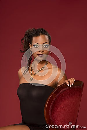  Chairs on With Dramatic Makeup Sitting On Red Chair Looking Directly To Camera