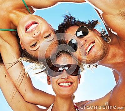 Group Of Happy Young Teenagers In Circle At Beach