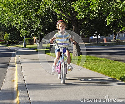 riding a bike. LITTLE GIRL RIDING A BIKE