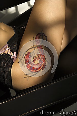 Royalty Free Stock Photography: Lizard tattoo on thigh.