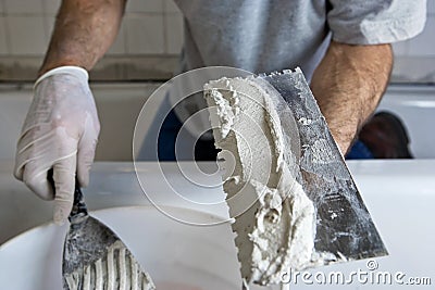 [Image: man-working-with-trowel-and-mortar-tilin...572817.jpg]