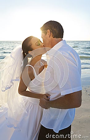 couple kissing sunset. MARRIED COUPLE KISSING AT
