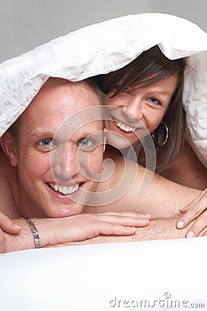 ROMANCE IN THE BED Young couple in 