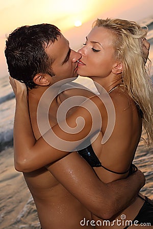 couple kissing sunset. ROMANTIC COUPLE KISSING AT