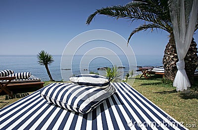 Striped Sunlounger And Sunny Sea Views Stock Photo