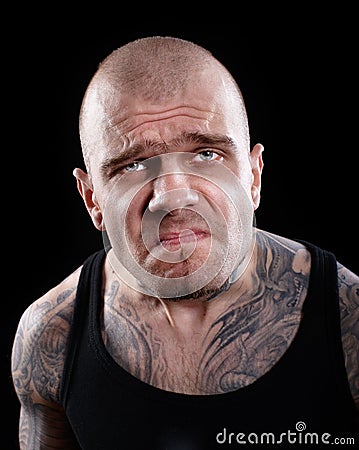 TATTOOED MAN WITH DISPLEASED