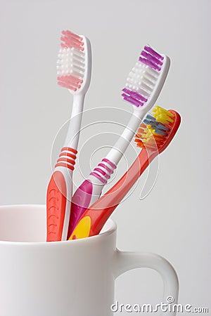 Stock Photo: Three toothbrushes in a cup, family concept