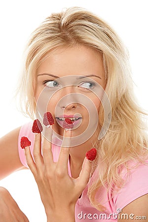 Stock Photo: Woman eating raspberries off fingers