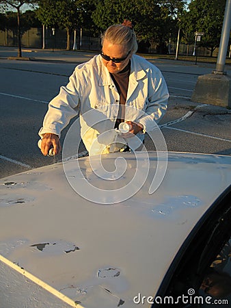 WOMAN SPRAY PAINTING CAR (click image to zoom)