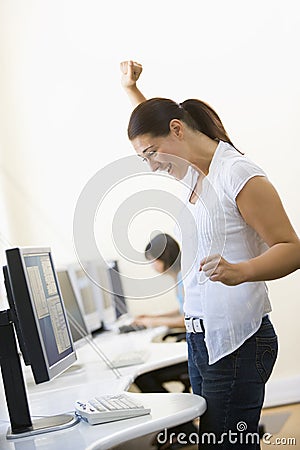 Royalty Free Stock Images: Woman standing in computer room cheering. Image: 5709189