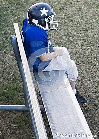 youth-football-player-alone-on-the-bench-thumb3732687.jpg