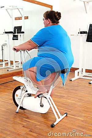 overweight-woman-exercising-on-bike-thum